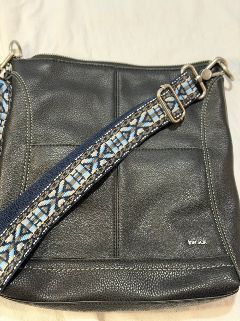 The Sak Lucia Black Pebbled Leather Crossbody Bag with Woven Strap